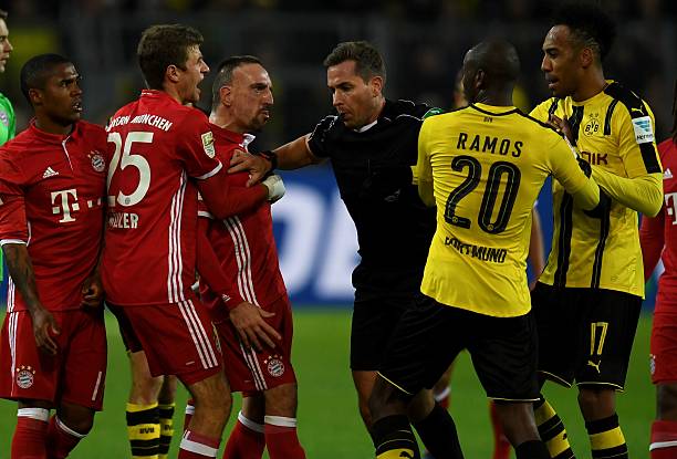 Bayern Munich vs. Borussia Dortmund best rivalries in football history Referee Tobias Stieler (C) breaks up a scuffle between Dortmund's Columbian striker Adrian Ramos and Bayern Munich's French midfielder Franck Ribery during the German first division Bundesliga football match between Borussia Dortmund and FC Bayern Munich in Dortmund on November 19, 2016. / AFP / PATRIK STOLLARZ /