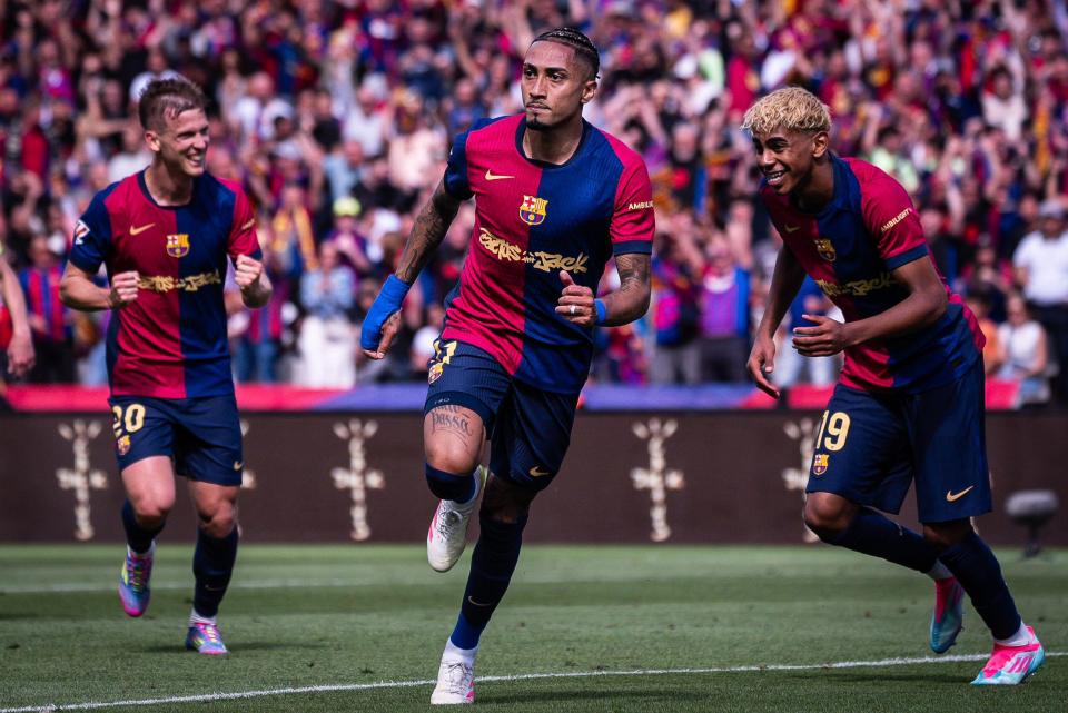 Three Barcelona soccer players celebrating a goal.