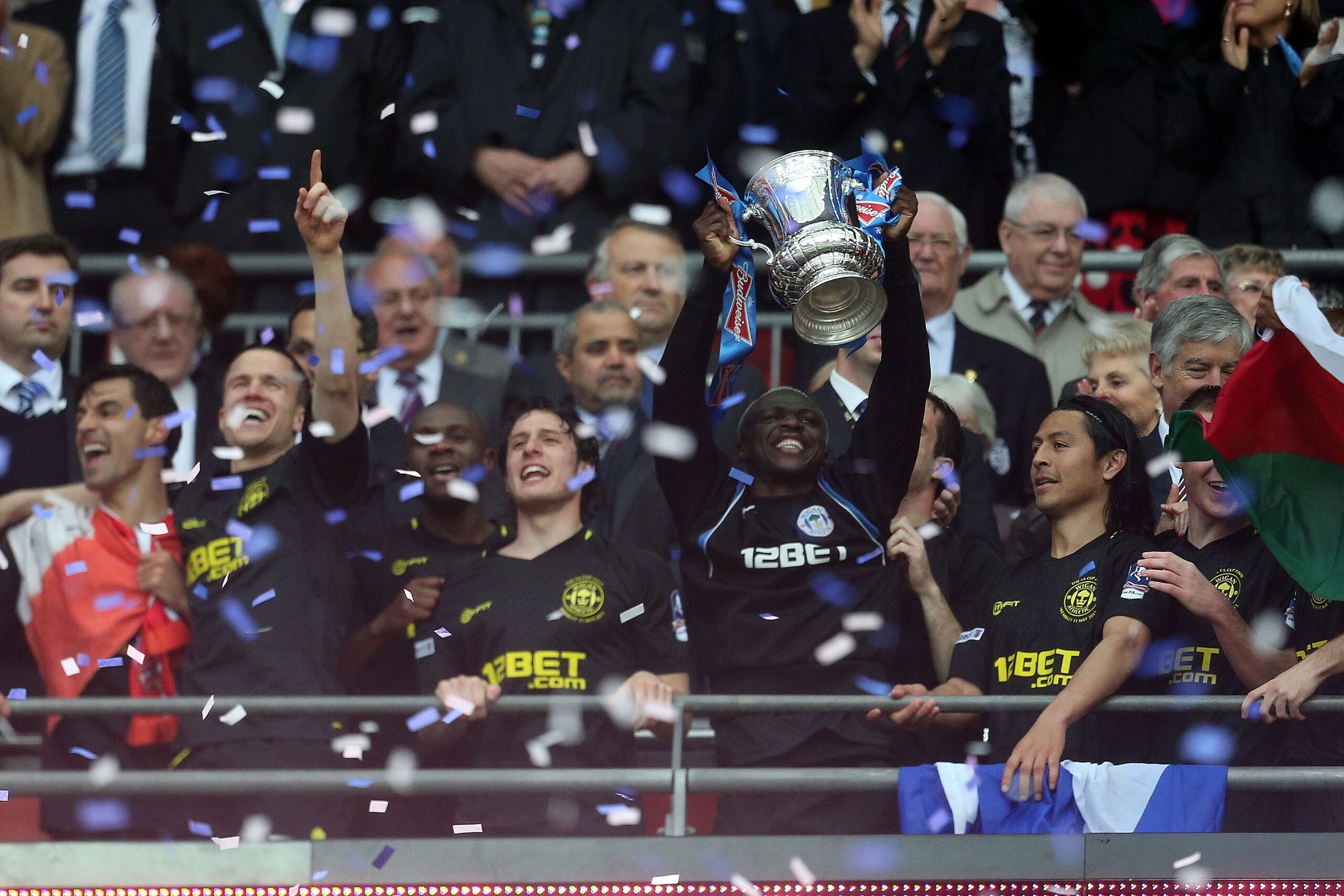 Wigan Athletic players celebrate with the trophy after their FA Cup final win over Manchester City in May 2013.