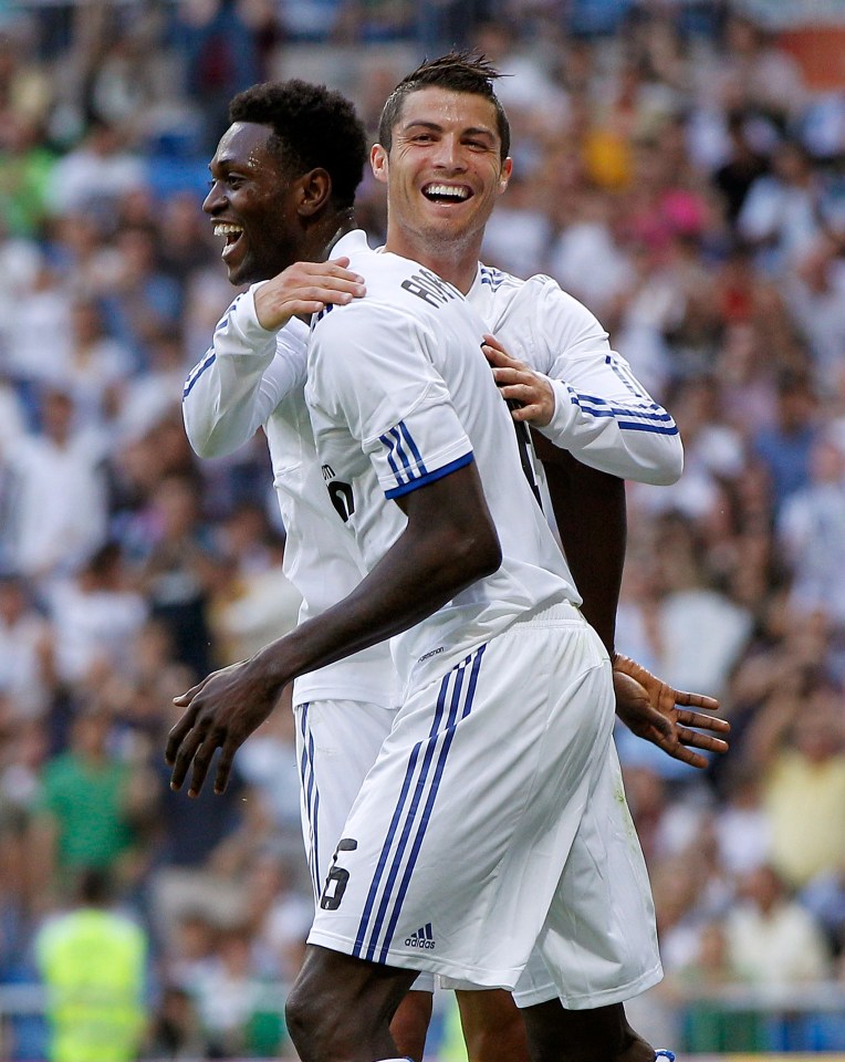 Cristiano Ronaldo and Emmanuel Adebayor of Real Madrid celebrating a goal.