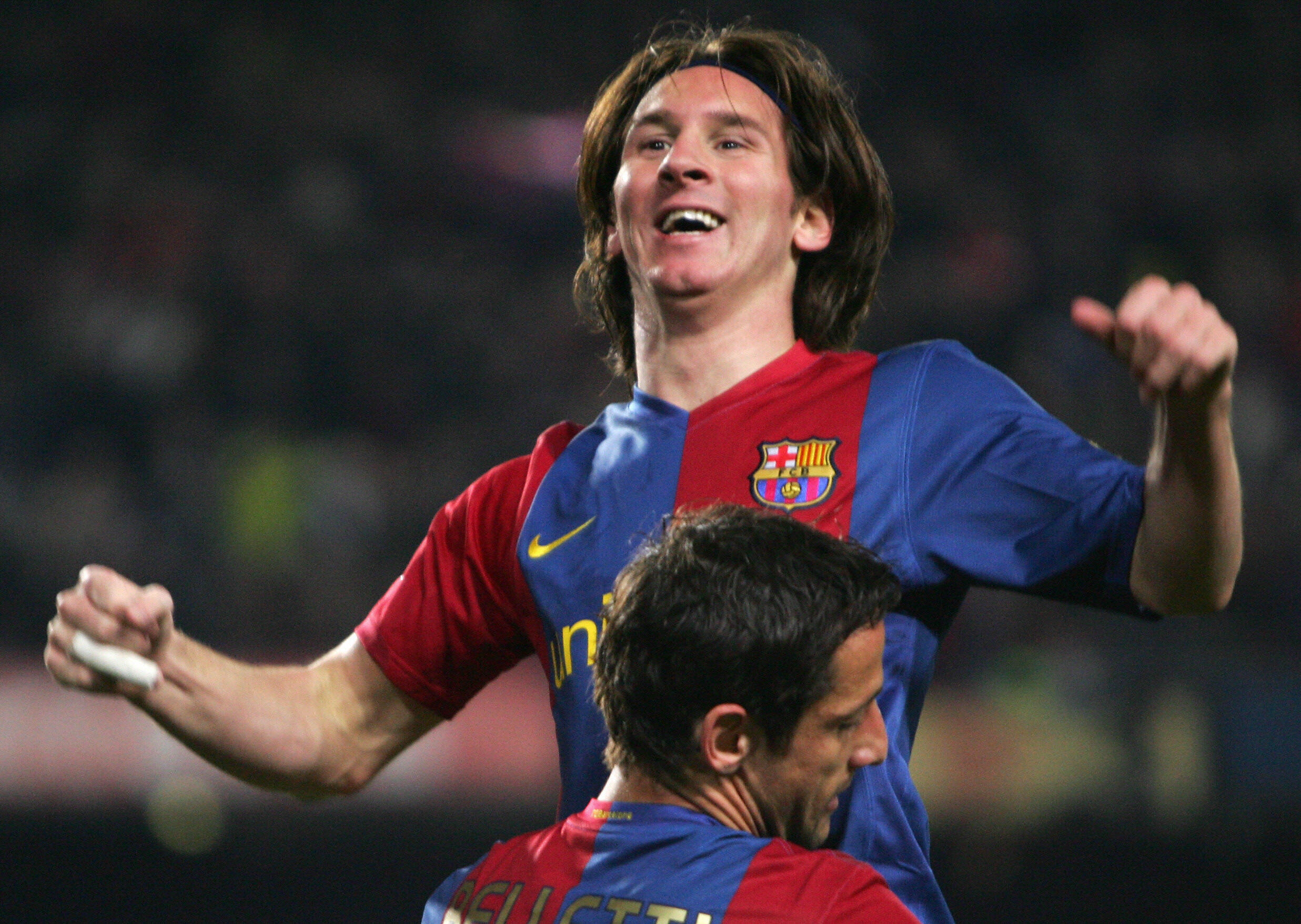 Lionel Messi celebrates with Juliano Belletti after scoring his third goal in a 3-3 draw with Real Madrid at Camp Nou in March 2007.