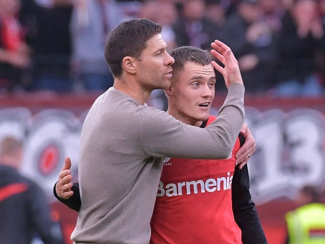 Xabi Alonso and Florian Wirtz of Bayer Leverkusen during their side's Bundesliga clash against Eintracht Frankfurt, on October 19, 2024