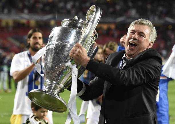 Carlo Ancelotti football coaches with the most trophies Real Madrid's Italian coach Carlo Ancelotti celebrates their victory with the trophy at the end of the UEFA Champions League Final Real Madrid vs Atletico de Madrid at Luz stadium in Lisbon, on May 24, 2014. Real Madrid won 4-1. AFP PHOTO/ FRANCK FIFE (Photo by Franck FIFE / AFP)